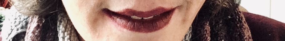 White womanâ€™s lips with dark lipstick